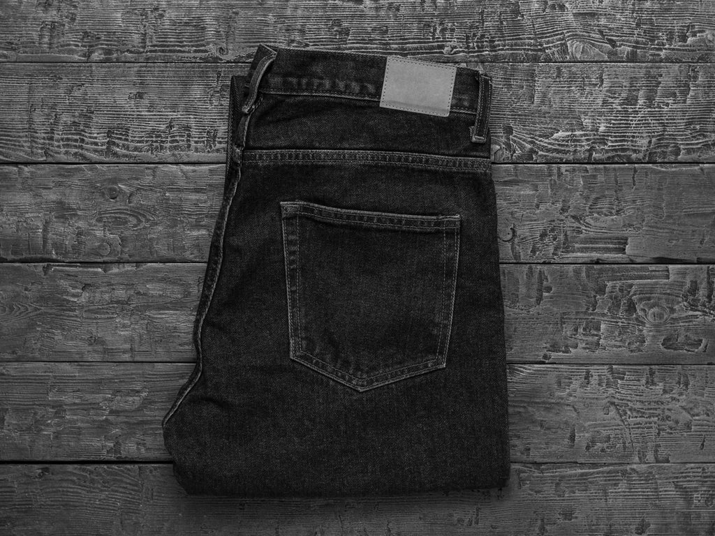 black-white-image-stylish-men-s-jeans-wooden-table-classic-denim-clothing-flat-lay-view-from-top_11zon